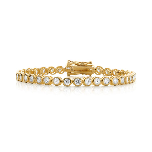 Gold bracelet with clear stones on a white background