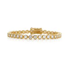 Gold bracelet with clear stones on a white background