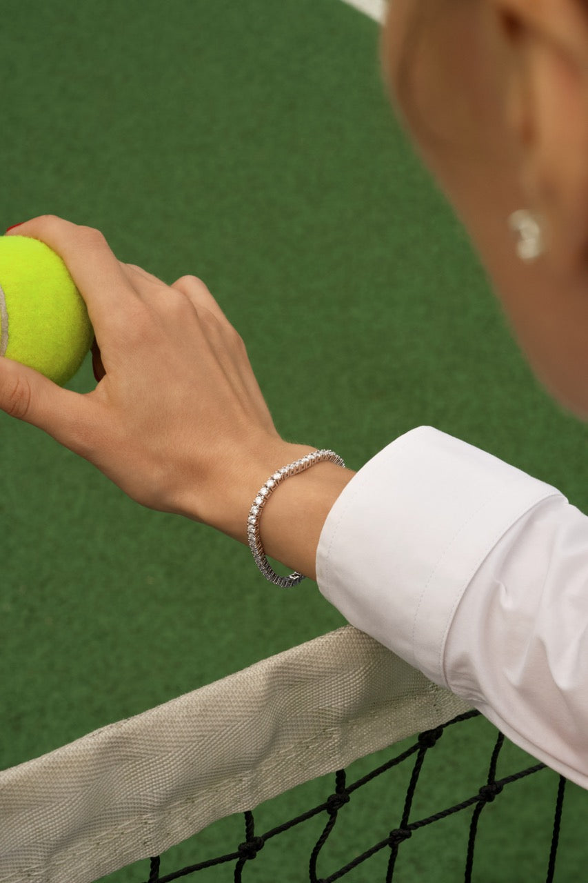 Women playing tennis whilst wearing a tennis bracelet